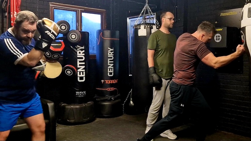 Group boxing training session with multiple members at Boxing Fitness MK gym