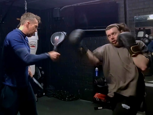 Man receiving boxing pad training from professional coach at Boxing Fitness MK