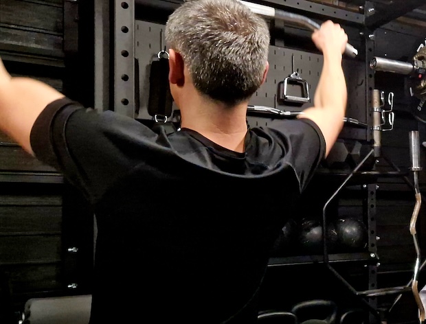 Man performing pull-up strength training exercise at Boxing Fitness MK gym in Milton Keynes